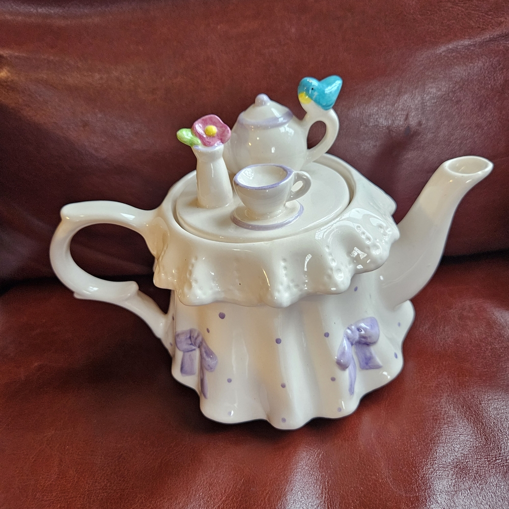 Charming White and Purple Teapot with Decorative Accents